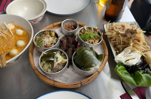Original photo of noodle soup, a bamboo platter of Lao dishes and papaya salad at Bistro Lao.